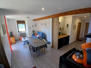 a living room with a table and a dining room at La Maison de Valie in Mercoeur