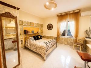 a bedroom with a bed and a mirror at B&b Villa Romano in Salerno +27 photos