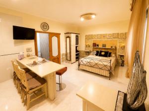 a room with a bed and a table and a dining room at B&b Villa Romano in Salerno