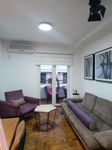 a living room with a couch and a table at Budva apartman Haustor in Budva +51 photos