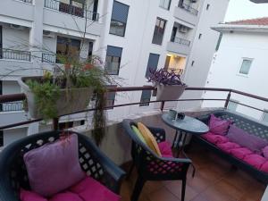 a balcony with two couches and a table and chairs at Budva apartman Haustor in Budva