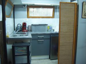 a small kitchen with a sink and a microwave at Chalet de campagne LAJA only 5 min from autoroute A75 in Léotoing