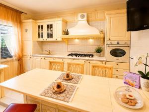 a kitchen with a table and a stove top oven at B&b Villa Romano in Salerno