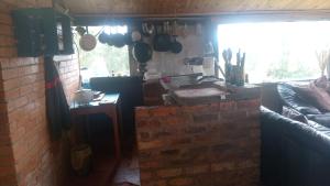 a kitchen with a brick wall and a window at Luna Llena in Suesca +1 photo
