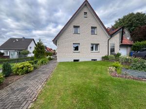 a large white house with a grass yard at Ferienwohnung Schöne Aussicht in Nieheim