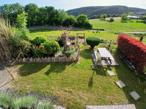 an aerial view of a garden with a bench at La Maison de Valie in Mercoeur