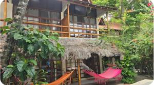 a resort with two hammocks in front of it at Hotel Sumpa in Montañita