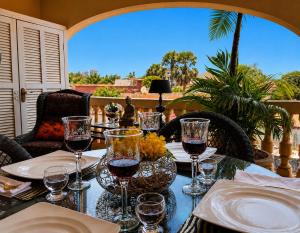 a table with glasses of wine on a patio at RoofTop Boutique Hotel Adults Only in Serekunda
