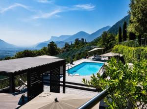 a villa with a swimming pool and mountains in the background at Residence Pranterhof in Marlengo