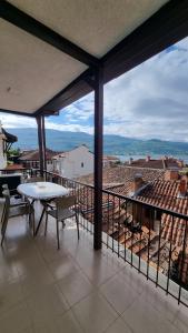 a balcony with a table and chairs and a view at Lukanov Apartments - Lake view in Ohrid
