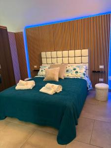 a bedroom with a large bed with towels on it at Caterina City House in Monopoli