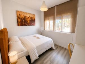 a bedroom with two beds and a painting on the wall at Centrico apartamento en Leganes in Leganés