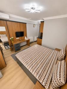 a bedroom with a large bed and a television at Asil house in Istanbul
