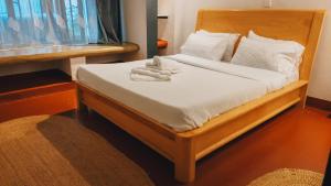 a bedroom with a bed with white sheets and pillows at Unique Homestay in Karatu +129 photos