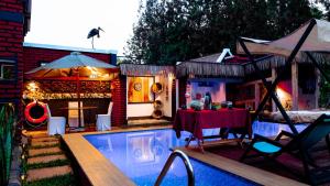 a backyard with a pool with a table and a tent at Unique Homestay in Karatu