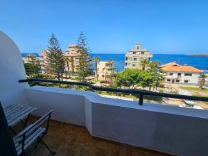 a balcony with a view of the ocean and buildings at Sunset Las Galletas in Las Galletas