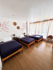 a room with two beds in a room at Killamoon House Paracas in Paracas +36 photos