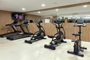 a row of exercise bikes in a gym at Apolo Suites Rentalmar in Salou +66 photos