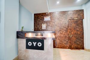 a sign on a counter in front of a door at Hotel O Royal Inn Hotel in Dīgha
