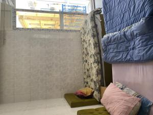 a room with a shower with a window and a couch at Hôtel Agriculture in Tunis +11 photos