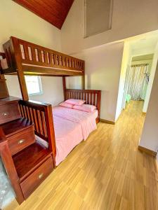 a bedroom with a bunk bed and a wooden floor at SSR Wasana in Sita Eliya