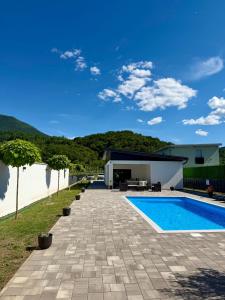 a backyard with a swimming pool and a house at Unavis Residence in Bihać