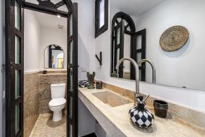 a bathroom with a sink and a toilet at Riad Kamil 4Suites - Private Pool - Rooftop Lounge in Marrakesh