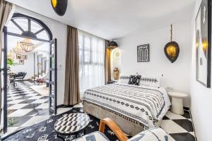a bedroom with a king sized bed and a hallway at Riad Kamil 4Suites - Private Pool - Rooftop Lounge in Marrakesh