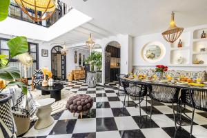 a living room with a black and white checkered floor at Riad Kamil 4Suites - Private Pool - Rooftop Lounge in Marrakesh
