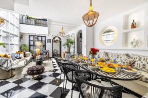 a living room with a table and chairs at Riad Kamil 4Suites - Private Pool - Rooftop Lounge in Marrakesh +30 photos