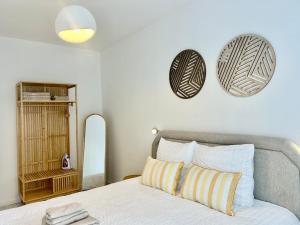 a bedroom with a bed with two mirrors on the wall at Brussels Expo & Atomium Prestige Suites in Grimbergen