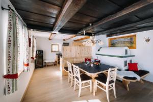 a room with a table and chairs and a bed at Ferienhaus Zirbenliebe Altenberg in Kurort Altenberg