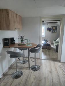 a kitchen with a table and stools in a room at Detmolder Perle 2 Charmante Dachgesschoswohnung im Altbau in Detmold +4 photos