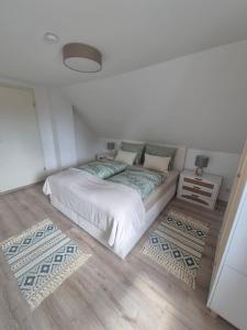 a bedroom with a large bed with two rugs at Detmolder Perle 2 Charmante Dachgesschoswohnung im Altbau in Detmold