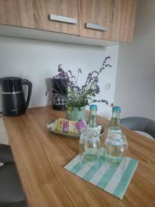 a table with two bottles of water on it at Detmolder Perle 2 Charmante Dachgesschoswohnung im Altbau in Detmold