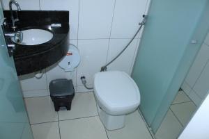a small bathroom with a toilet and a sink at Via Hotel in Monte Alegre de Minas