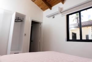 a bedroom with a bed and a window at Solaris Villa in Las Terrenas