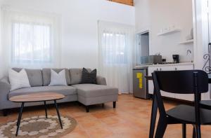 a living room with a couch and a table and a kitchen at Solaris Villa in Las Terrenas