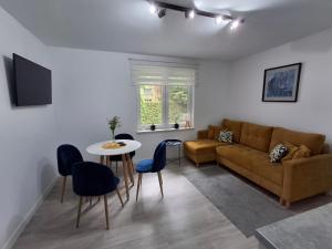 a living room with a couch and a table at Apartamenty Fredry in Lesko