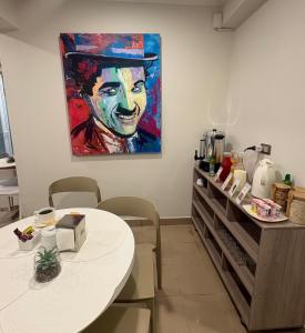 a room with two tables and a painting on the wall at Hotel Frontera in Antofagasta