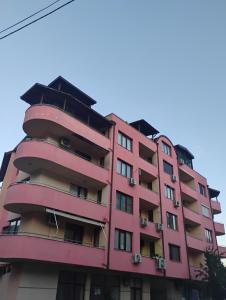 a pink apartment building with balconies at STADIUM 1 Apartments Sandanski in Sandanski