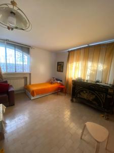 a bedroom with an orange bed and a fireplace at Comme chez moi in El Harhoura
