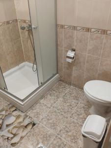 a bathroom with a shower and a toilet at STADIUM 1 Apartments Sandanski in Sandanski +12 photos