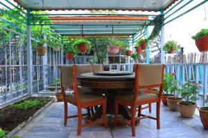 a table and chairs on a patio with plants at Roshan Plaza Hotel in Kabul +31 photos