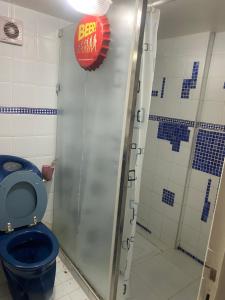 a bathroom with a blue toilet and a shower at Comme chez moi in El Harhoura