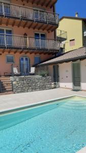 a swimming pool in front of a house at Il Giardino vista lago in Fonteno