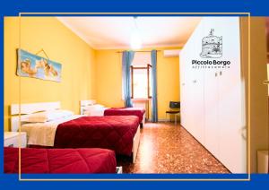 a hotel room with two beds and a door at Piccolo Borgo Affittacamere BIKE FRIENDLY in Taranto +22 photos
