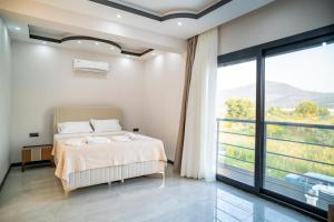 a bedroom with a bed and a large window at Villamona Dalaman in Bezkesen +49 photos