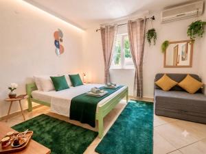 a small bedroom with a bed and a couch at Apartments Djurovic in Kotor