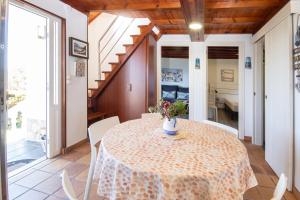 a dining room with a table and chairs at AG Casa Camariñas, con jardín y vistas al mar in Camariñas